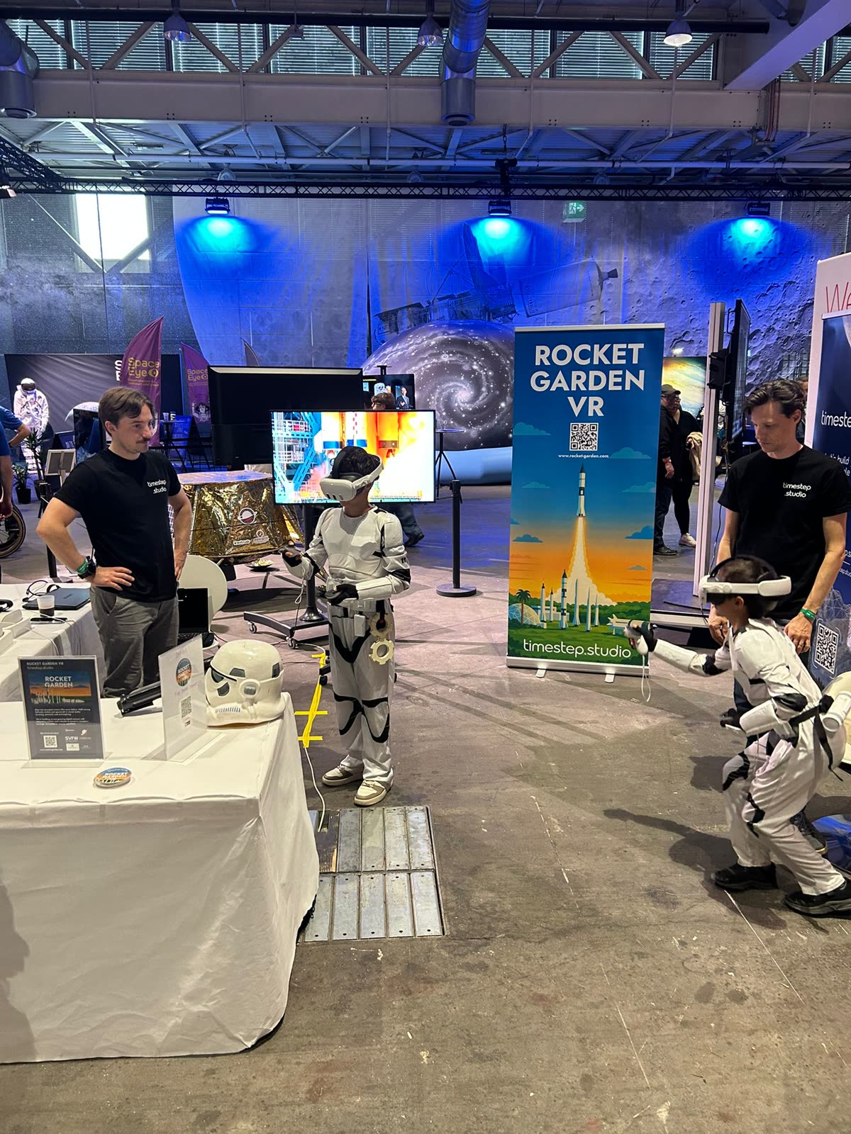 Two young visitors in stormtrooper costumes trying Rocket Garden on Meta Quest at the Space Zone booth